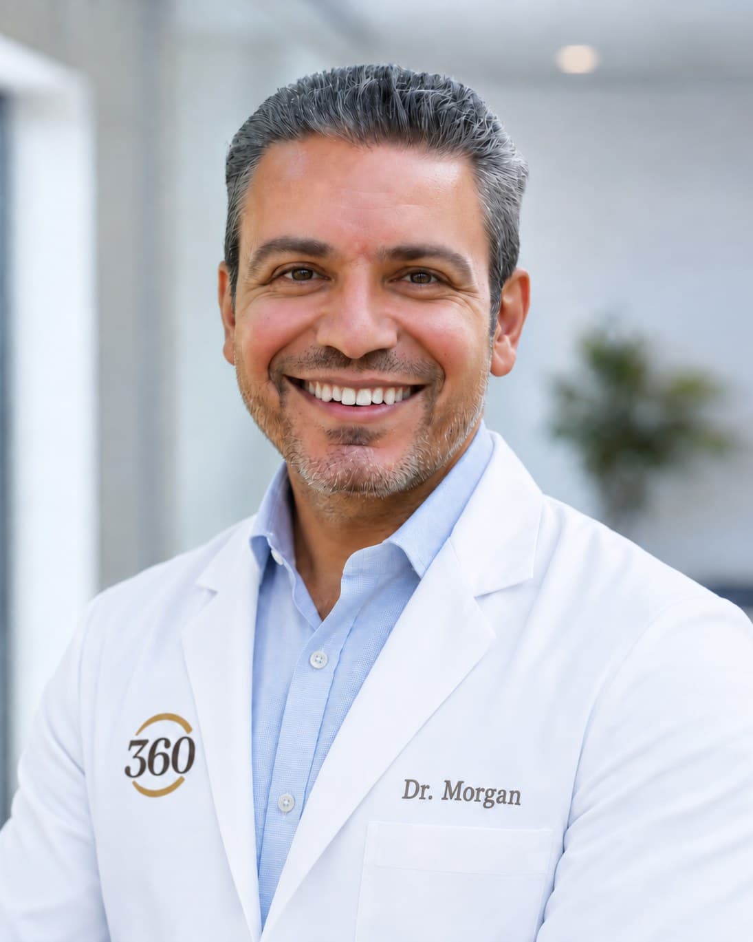 Dr. John Morgan, Medical Director at 360 Health Center, smiling in a white coat.